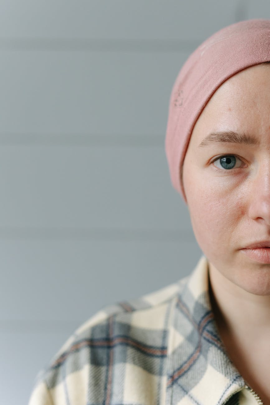 half face of a woman wearing pink bonnet