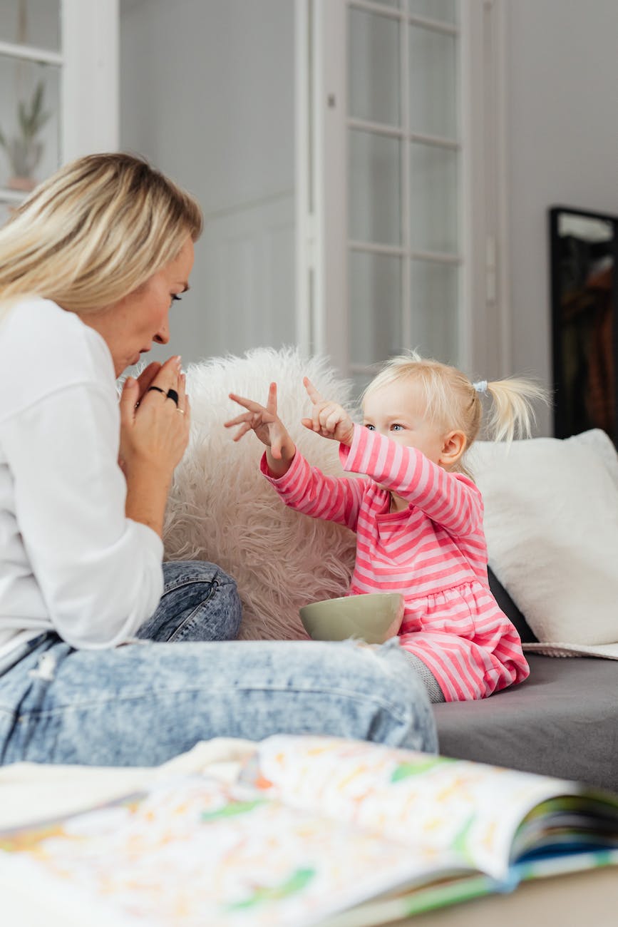 girl showing hands to mother