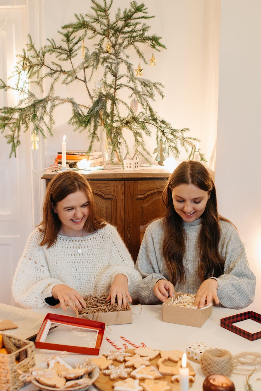 young girls boxing cookies for holidays